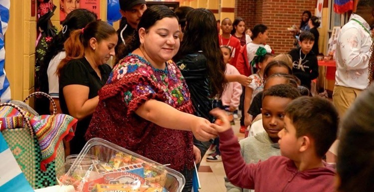 lady giving a child candy