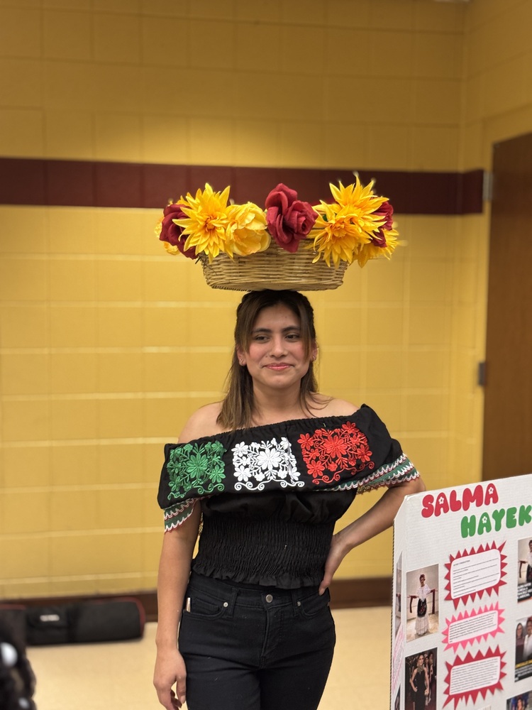 hispanic woman with a basket of flowers balanced on the head