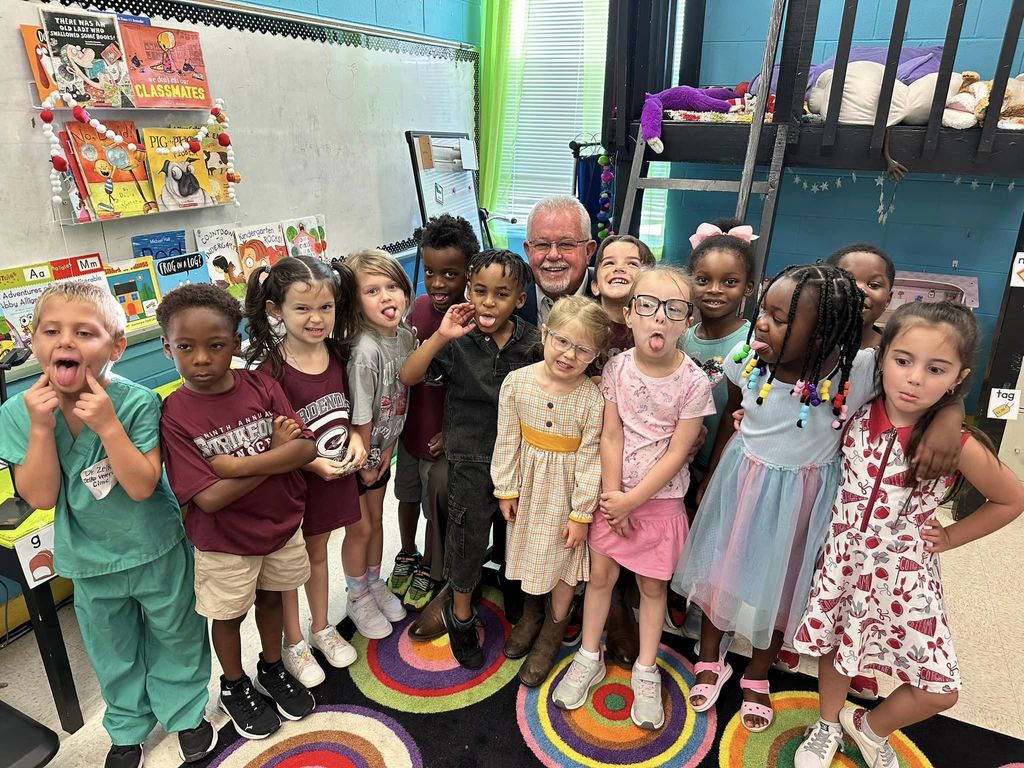 Kindergarten class making funny faces with Gardendale Mayor Hogeland