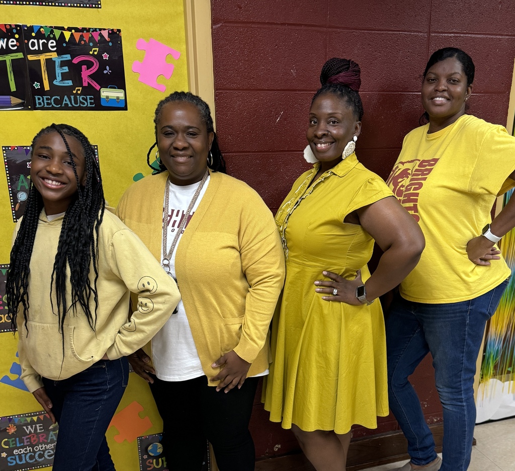 Three teachers and a student smiling