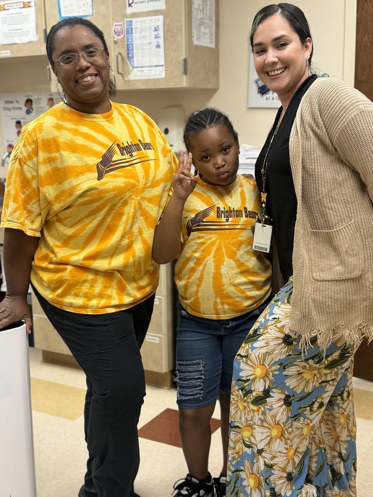 Two teachers and a student smiling