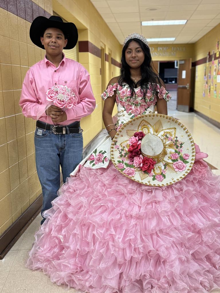 Two teenagers dressed in latin attire