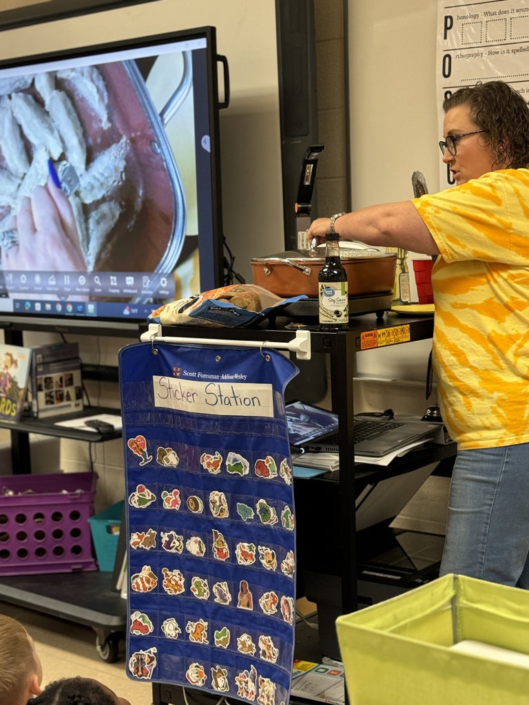 teacher stirring pot stickers in a skillet