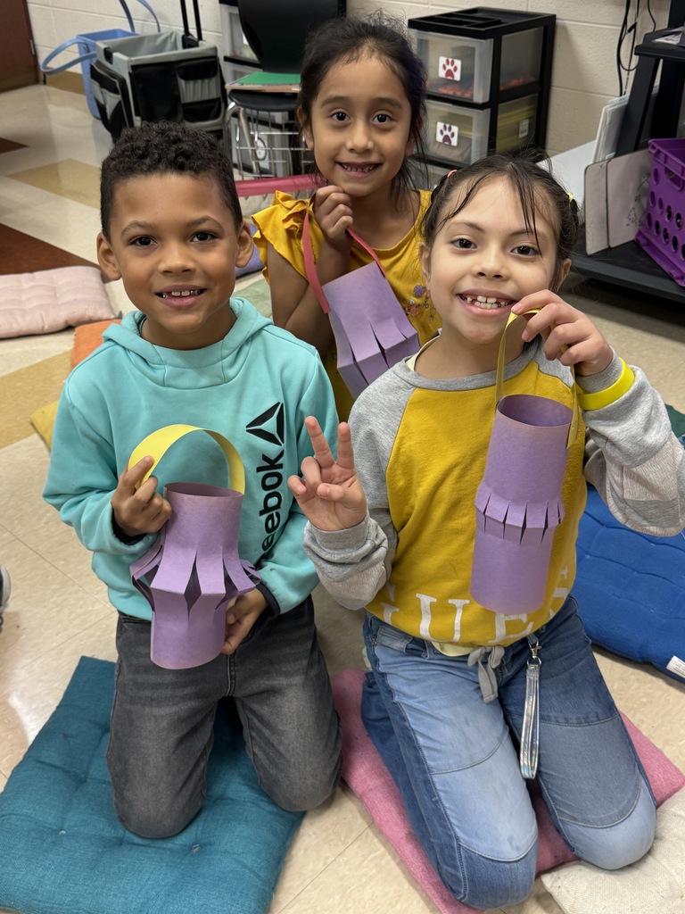 students holding up paper lanterns