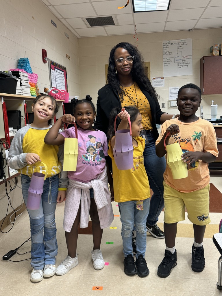 teacher and students holding up paper lanterns