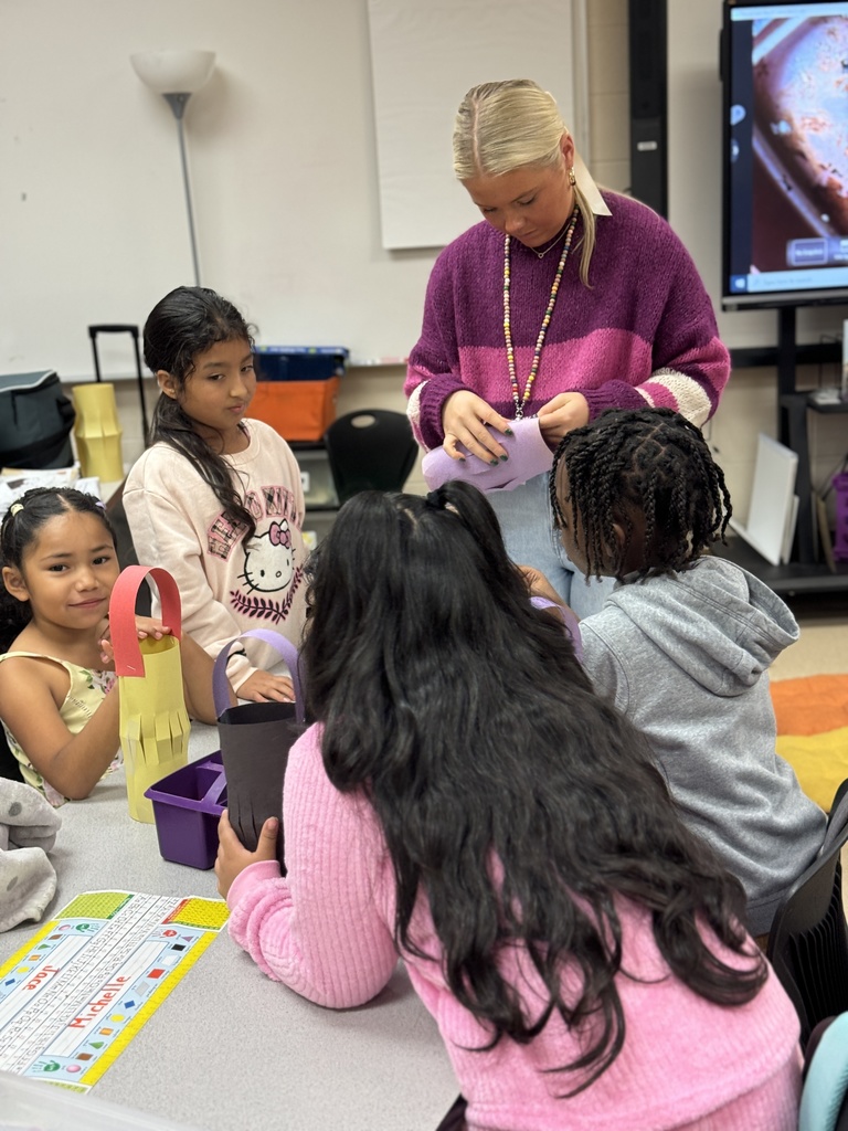 teacher and students cutting paper lanterns