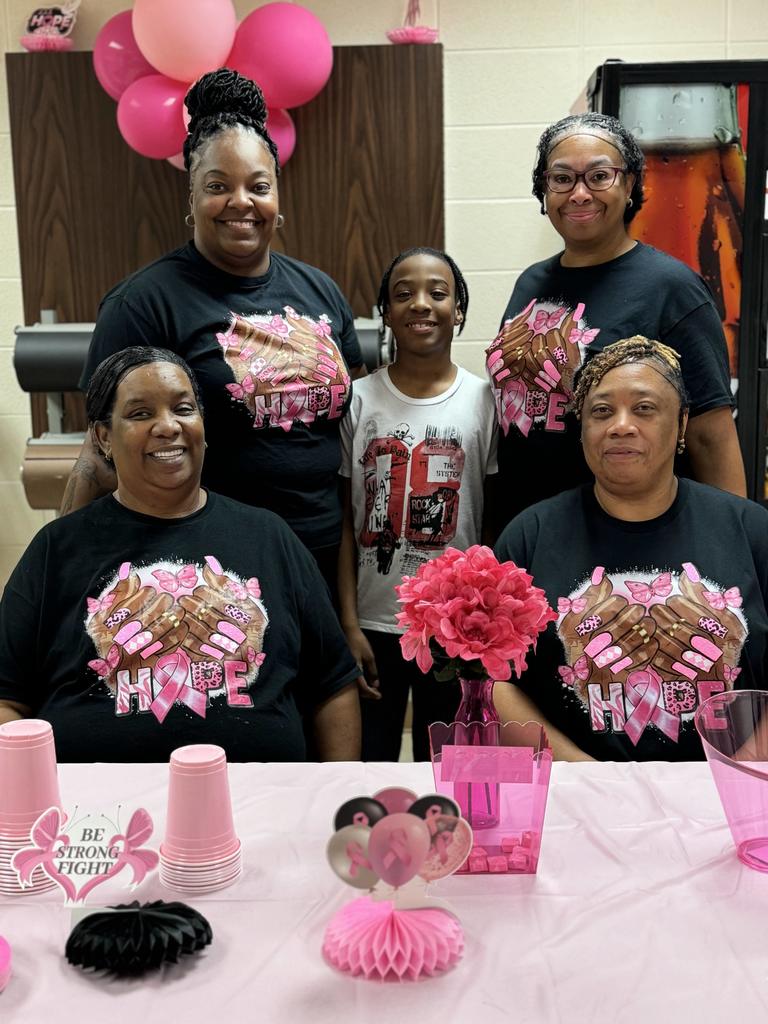 lunchroom staff and a student smiling