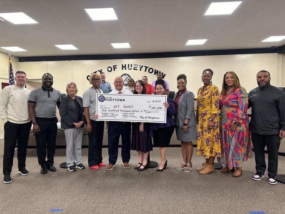 city council presenting a check to local school principals