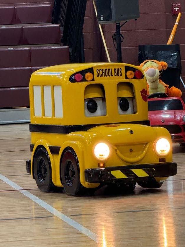 remote controlled toy school bus that has eyes and a mouth