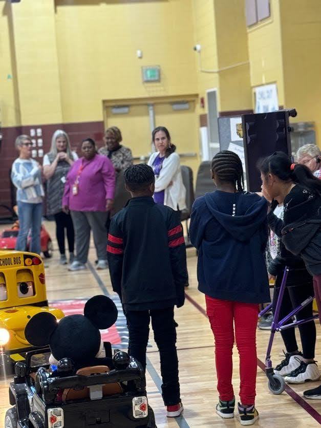 teachers and students standing, facing each other  and smiling