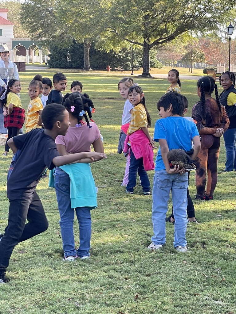 students standing on grass and playing agame