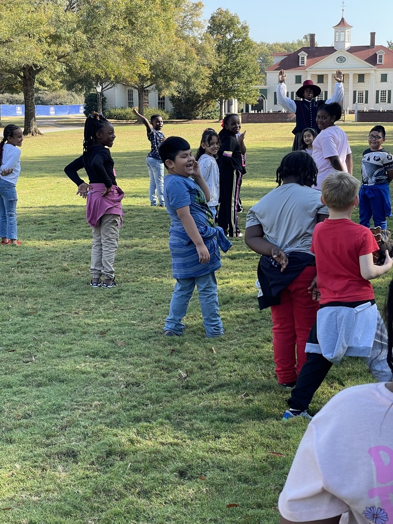 students standing on grass and playing agame