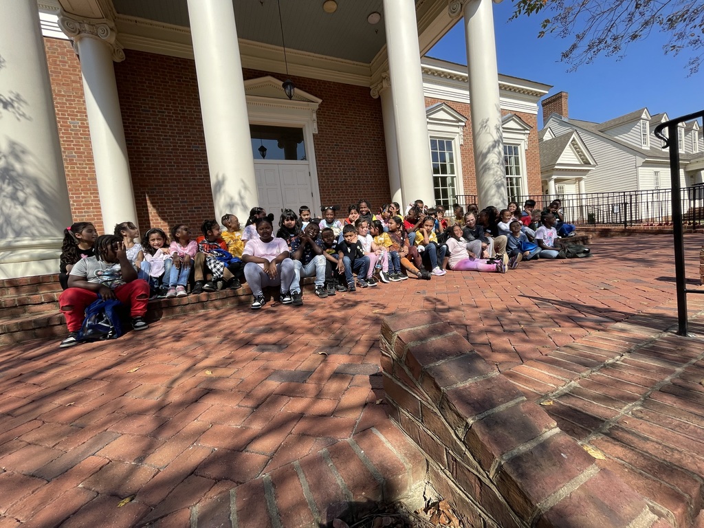 students standing in front of a building and posing for a group photo