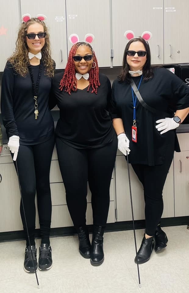 Employees dressed up for halloween as the three blind mice.