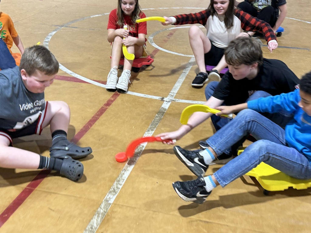 4th and 5th graders playing scooter hockey