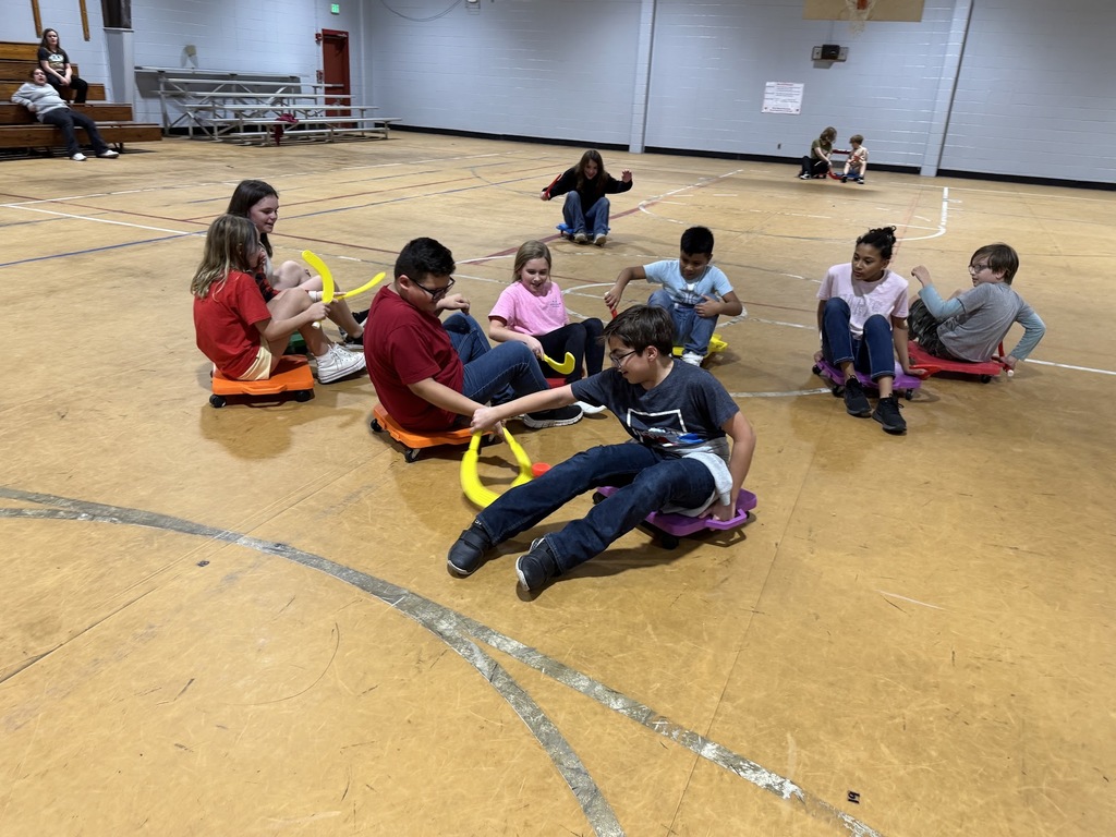 4th and 5th graders playing scooter hockey