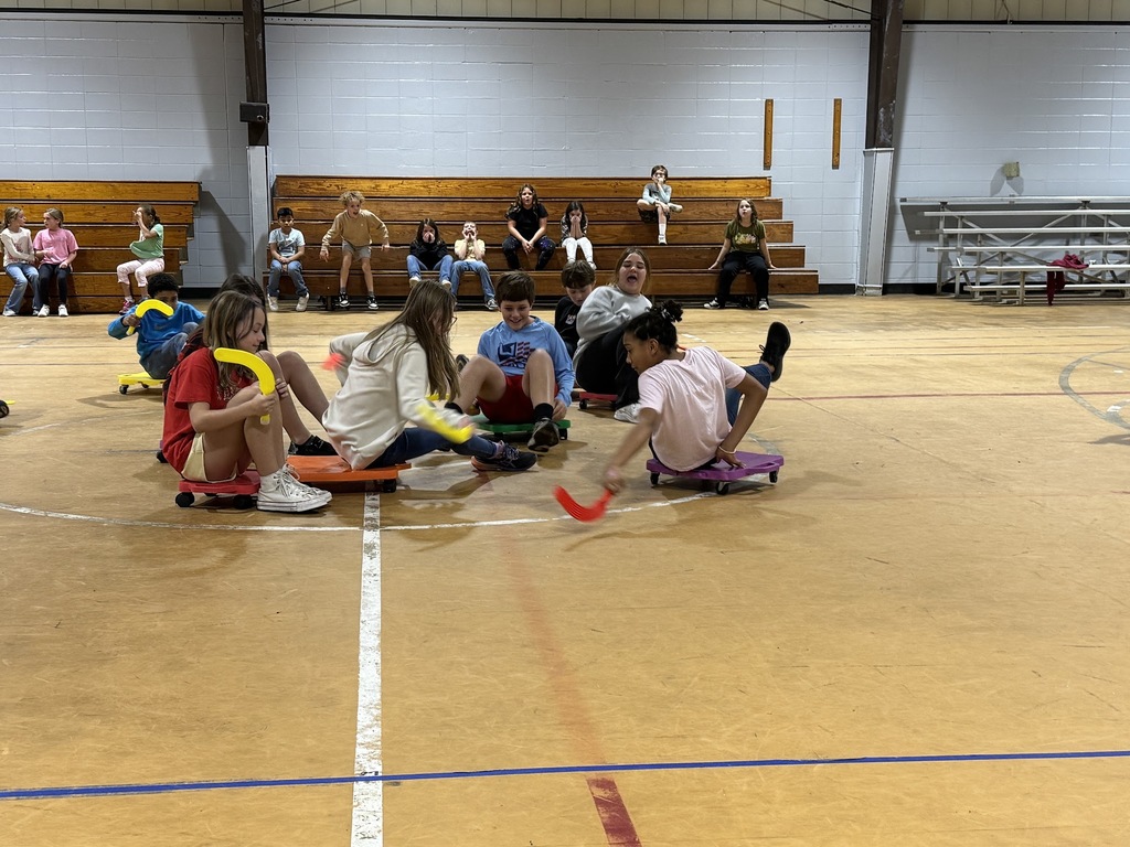 4th and 5th graders playing scooter hockey