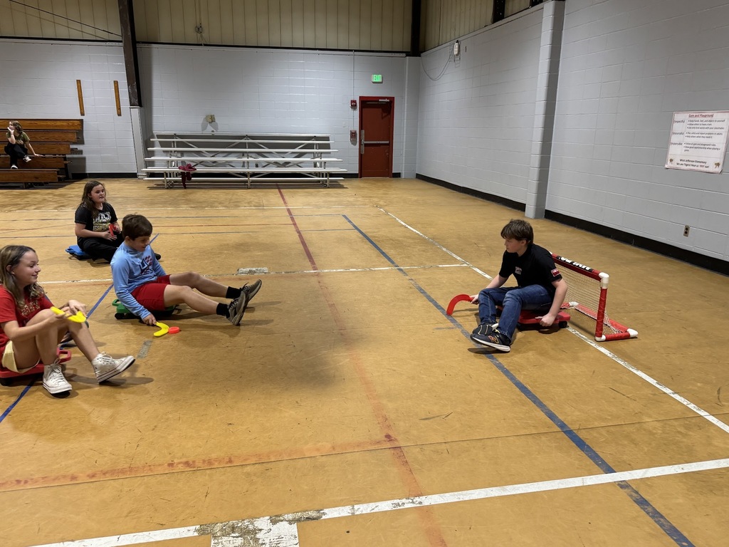 4th and 5th graders playing scooter hockey