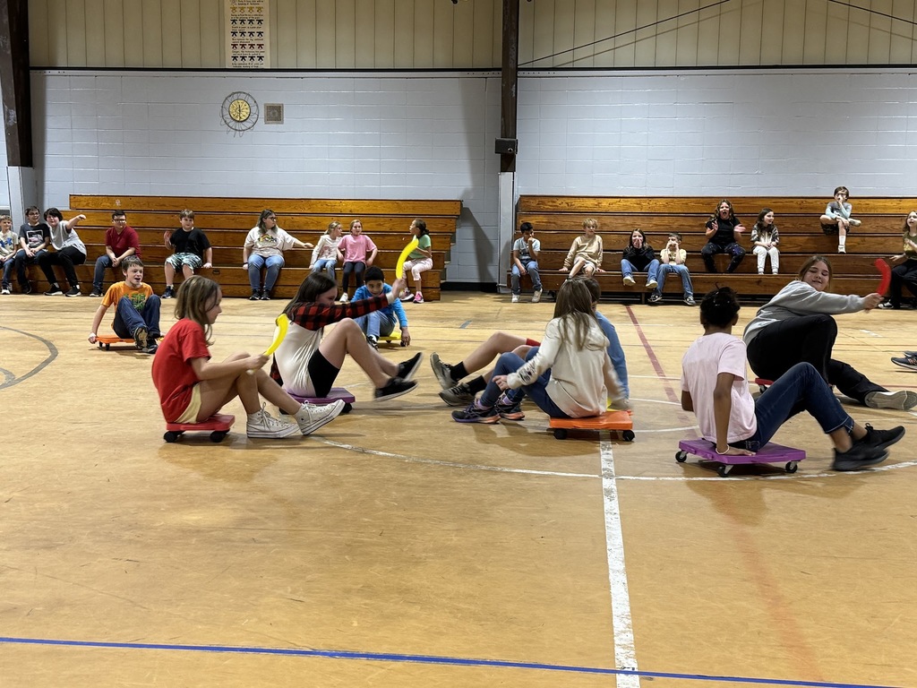 4th and 5th graders playing scooter hockey