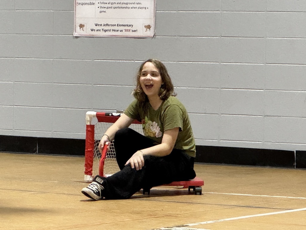 4th and 5th graders playing scooter hockey.