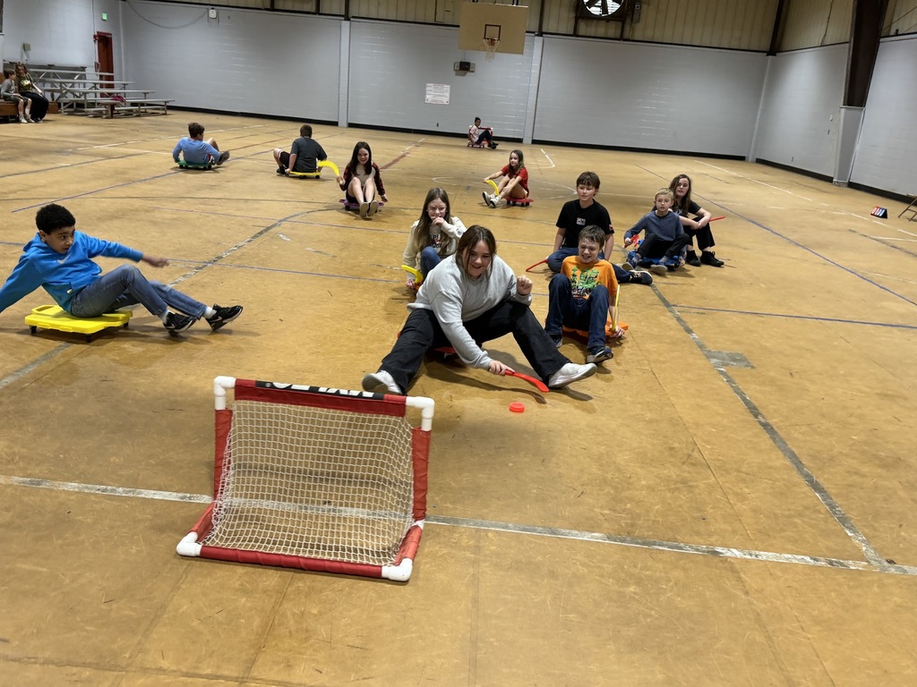 4th and 5th graders playing scooter hockey