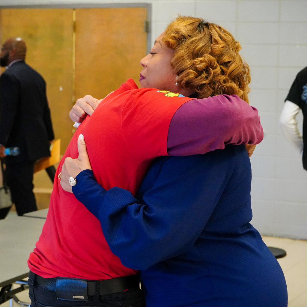 Commissioner Lashunda Scales is hugging a student