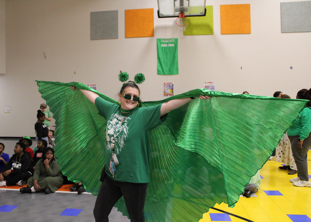 A teacher wears giant green wings during a house day celebration at Hueytown Intermediate School. 