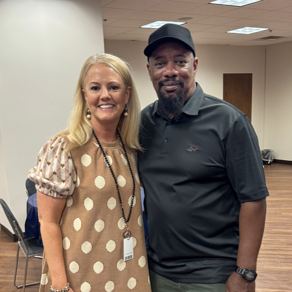 Dr. Laura Ware and Mr. Issac Pettway take a picture during Issac's retirement party.