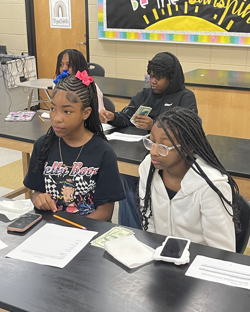 Female students learn about financial literacy during the Male presenter speaks to students during the Brotherhood & Girl Code Empowerment Summit 2025 at McAdory Middle School.