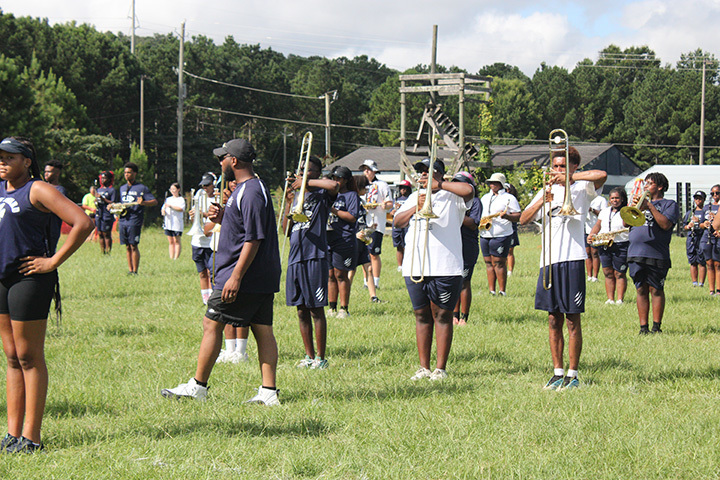 Band director works with students during summer band camp. 