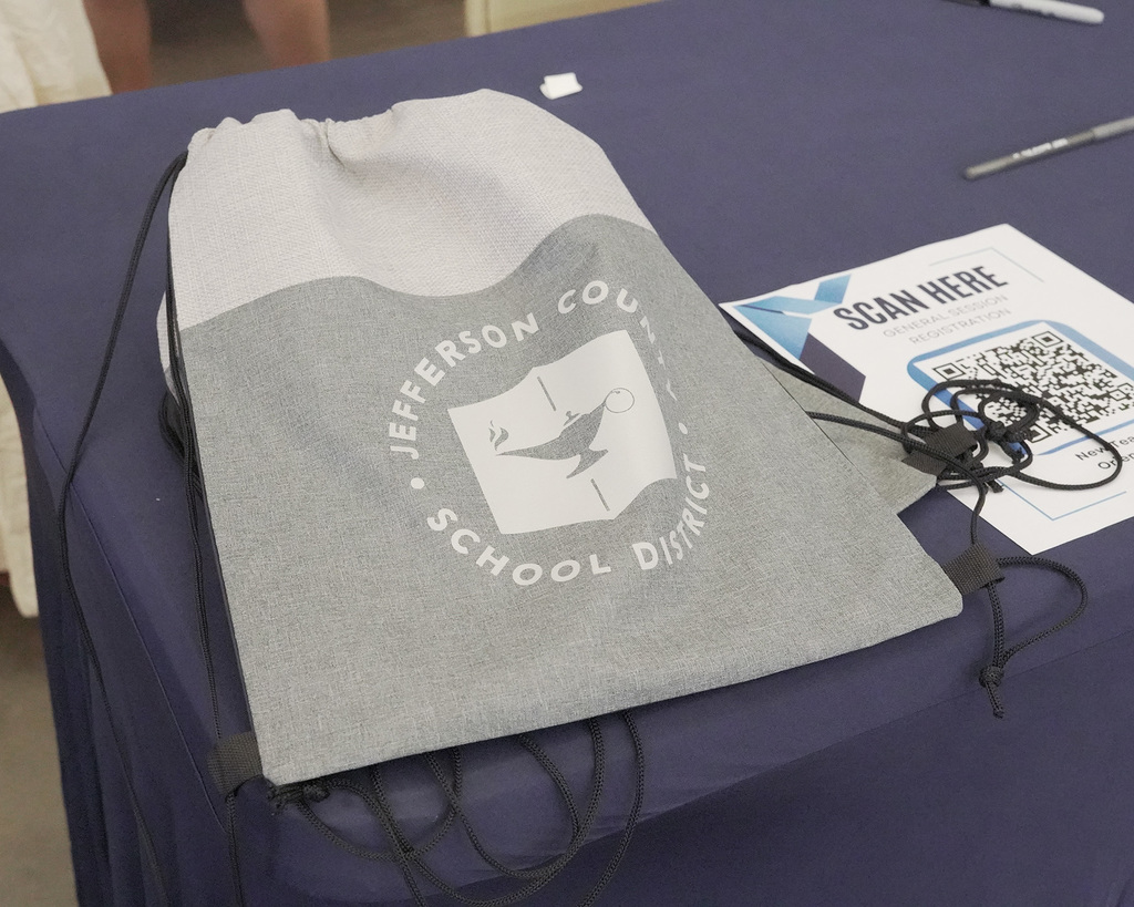 Jefferson County School District drawstring bag on a registration table