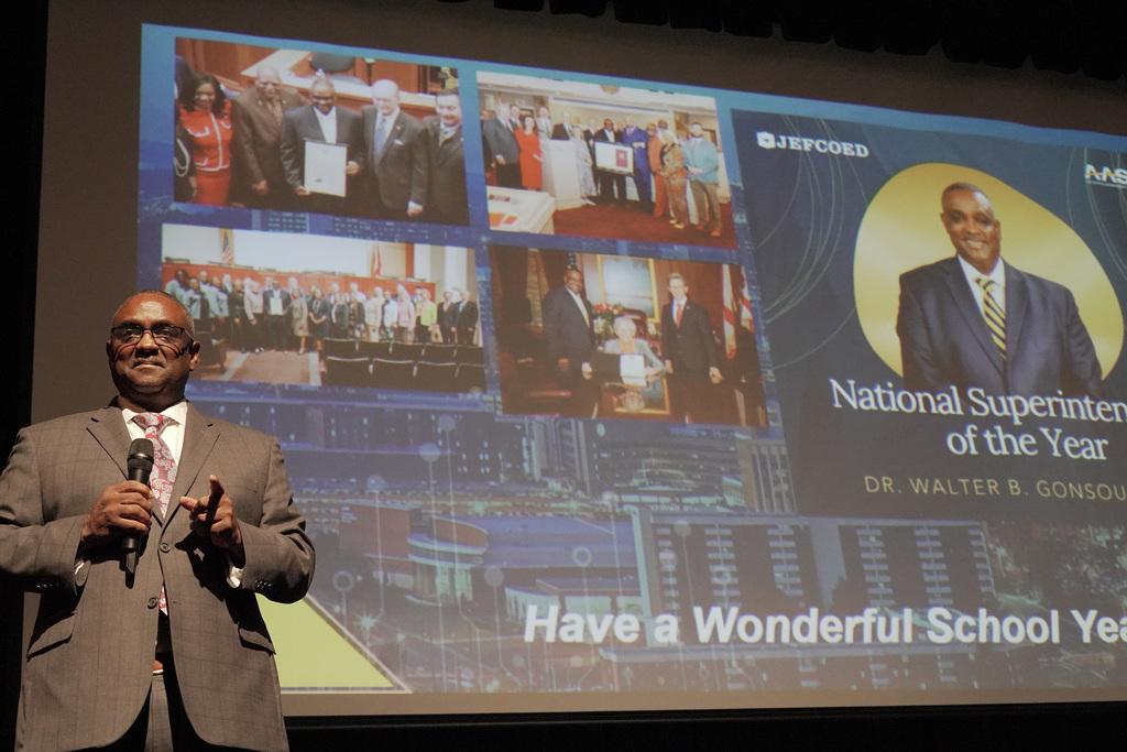 Superintendent Dr. Walter Gonsoulin speaking on stage during New Teacher Orientation.