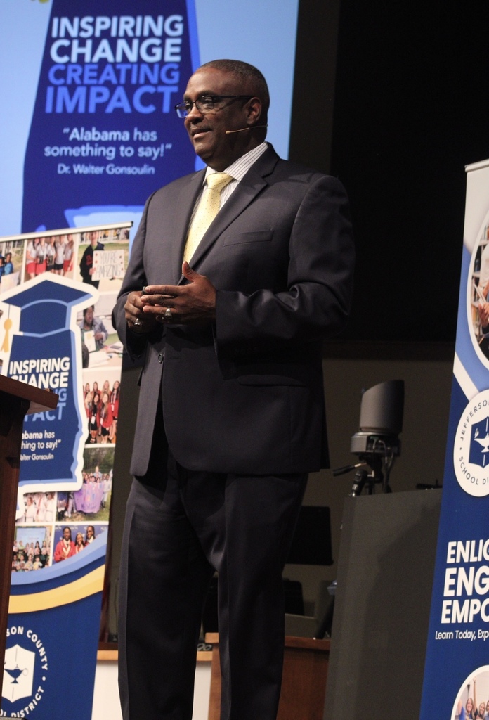 A man stands on a stage and talks