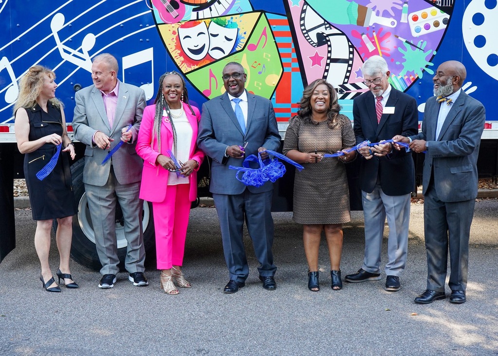 A group of leaders for Jefferson County Schools cuts the ribbon outside the new mobile art truck. 