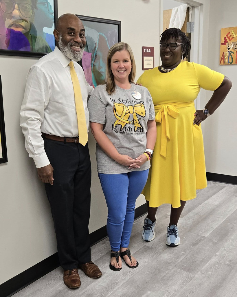 Dr. Terrence Brown poses with two staff members on "Go Gold" day. Promoting childhood cancer awareness. 