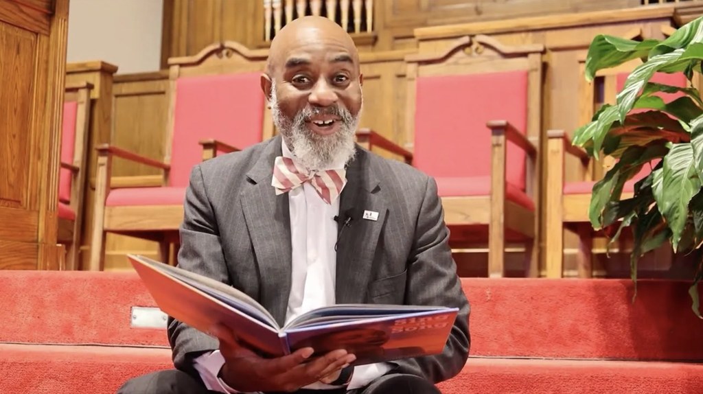 Dr. Terrence Brown reads a book. 