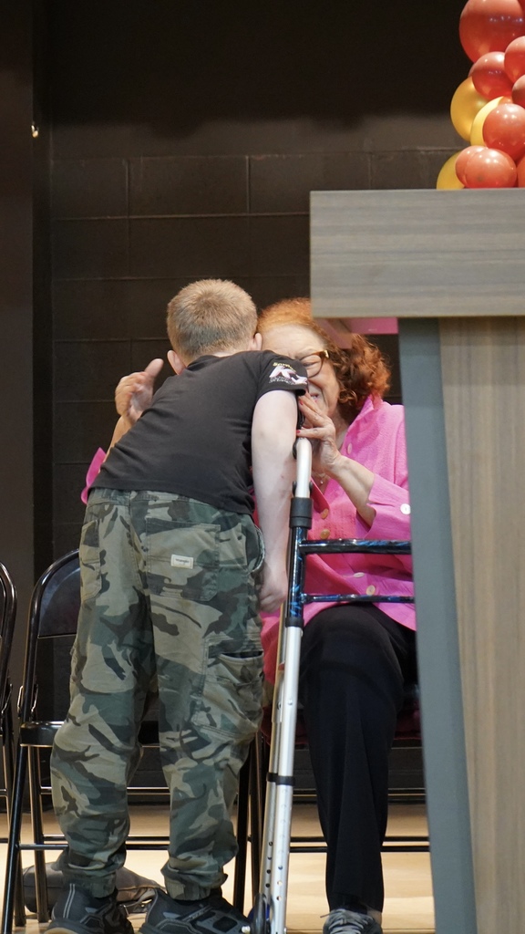 A little boy hugs a woman