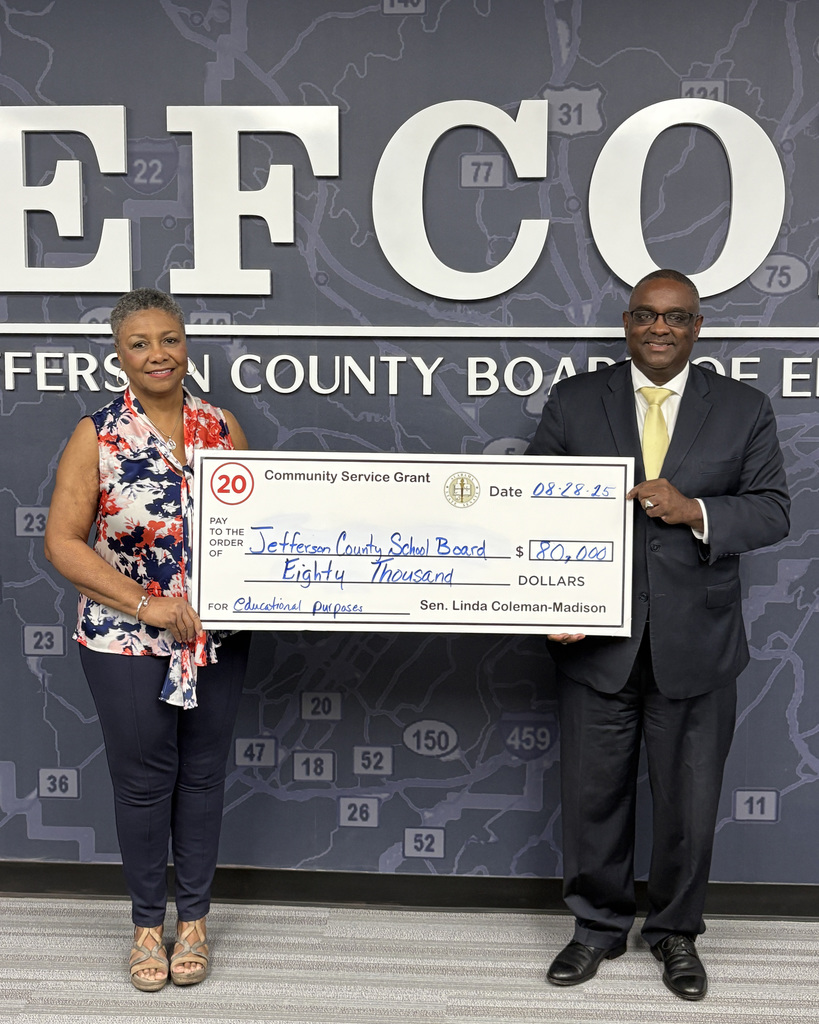 Senator Linda Coleman-Madison and Dr. Walter Gonsoulin hold a check to the Jefferson County School Board for $80,000.
