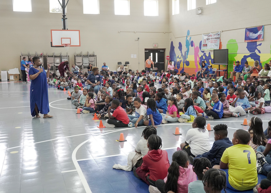 A large group of elementary students at a pep rally.