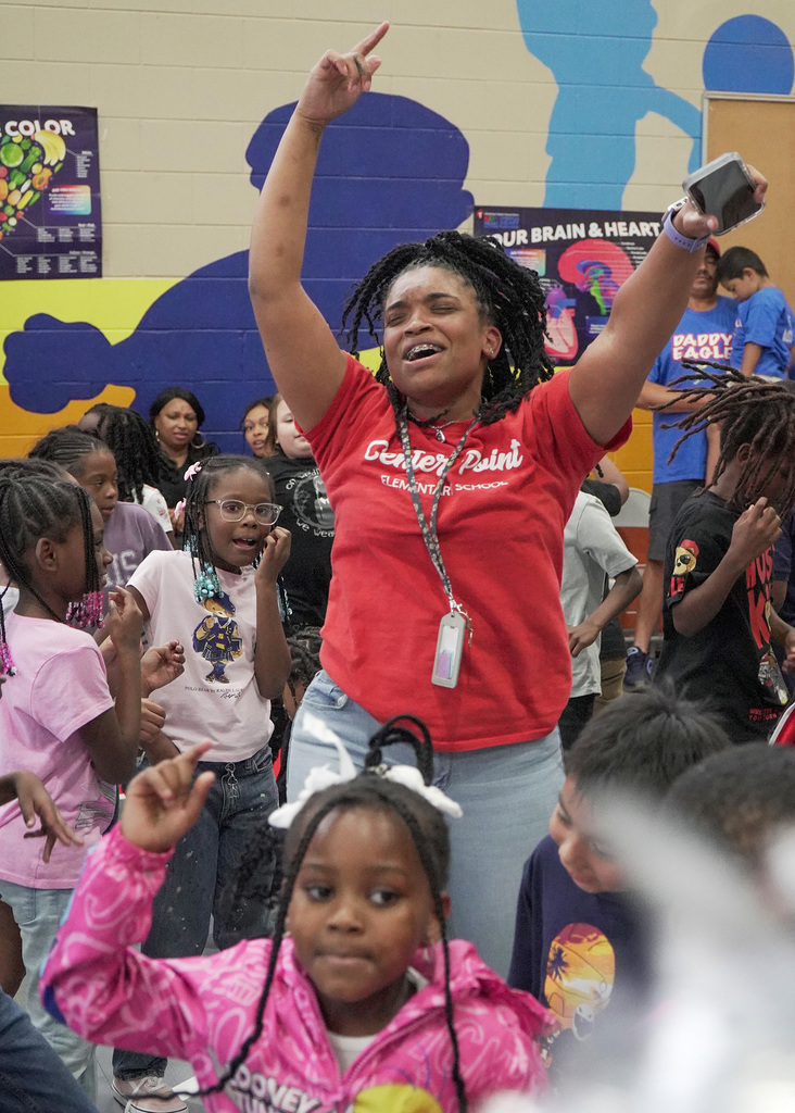 A woman dancing during a school pep rally.