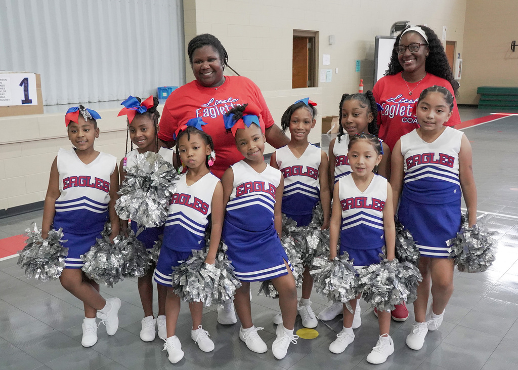 The Little Eaglettes cheer squad with their coaches.