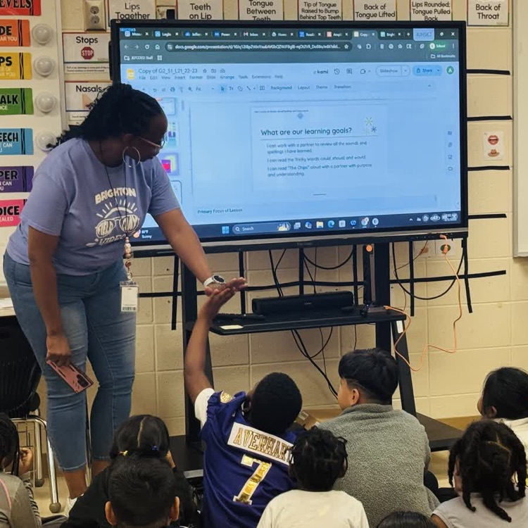teacher and kids working in the classroom