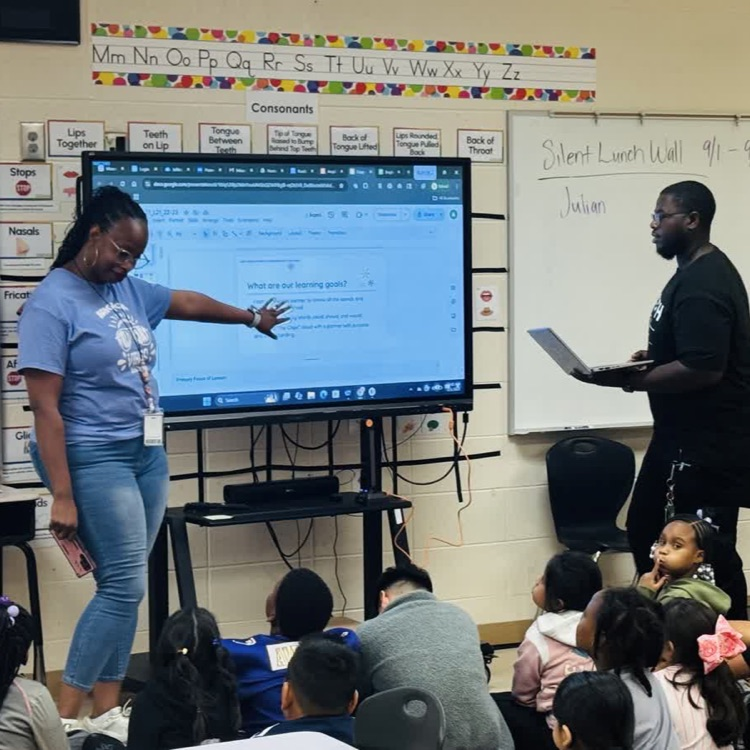 teacher and kids working in the classroom