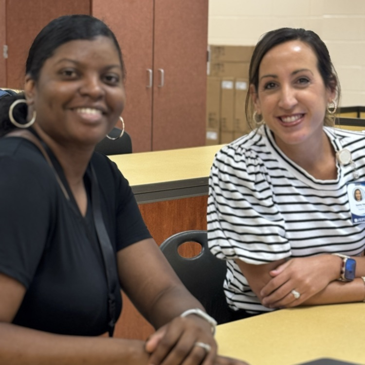two teachers smiling
