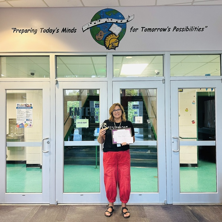 Gina Boyd is holding a plaque telling she is the Employee of the Month.