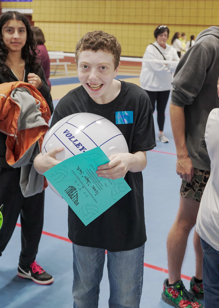Student holds volleyball during adaptive PE event. 