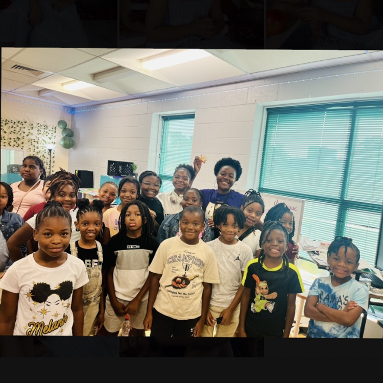 Mrs. Daniels and her students are posing for a picture.