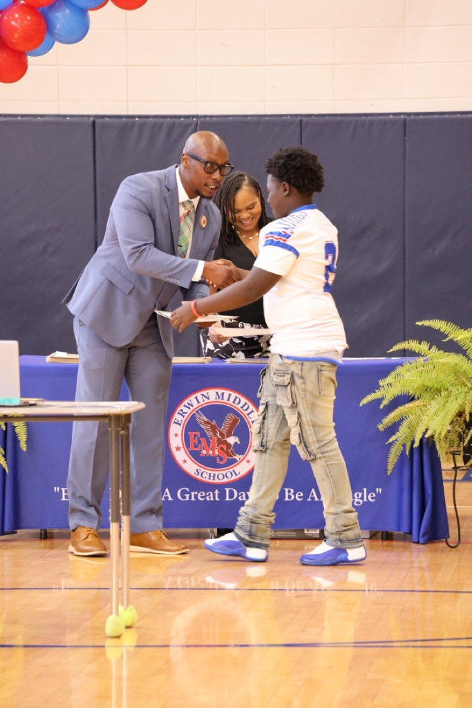 dr. Jones handing a student an award