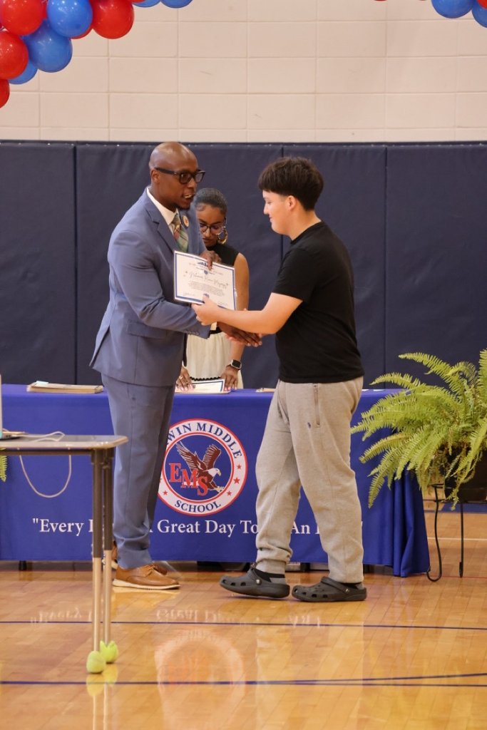 dr. Jones handing a student an award