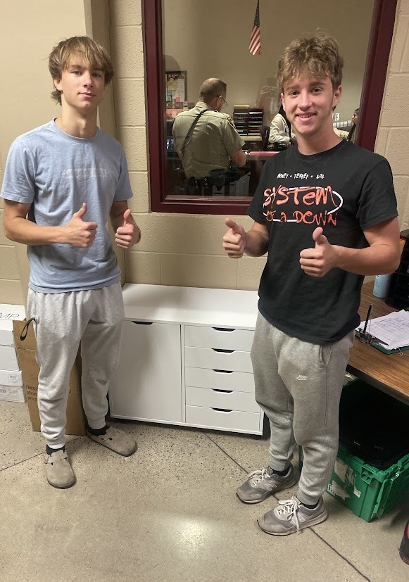 Office Aides assembling a cabinet 